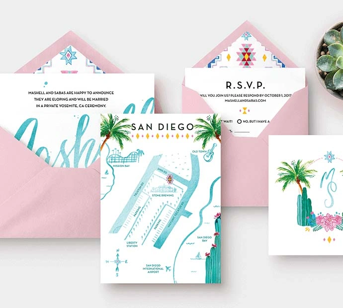 Wedding invitation suite featuring palm trees, elegantly presented with a pink envelope.